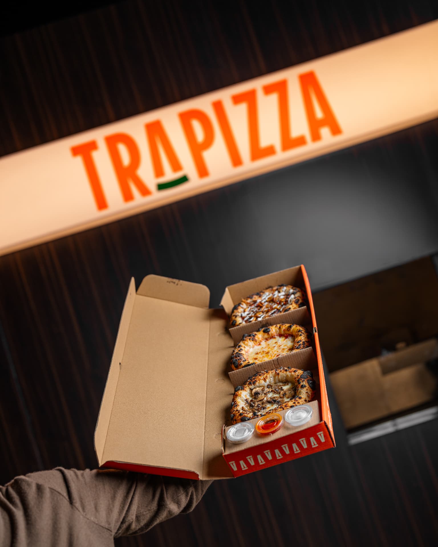 Trapizza box under the sign