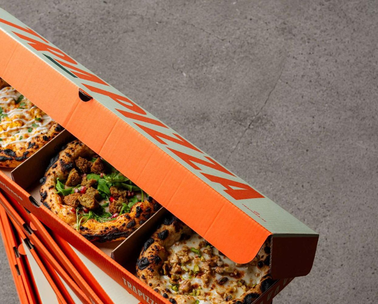 Trapizza box opened on concrete